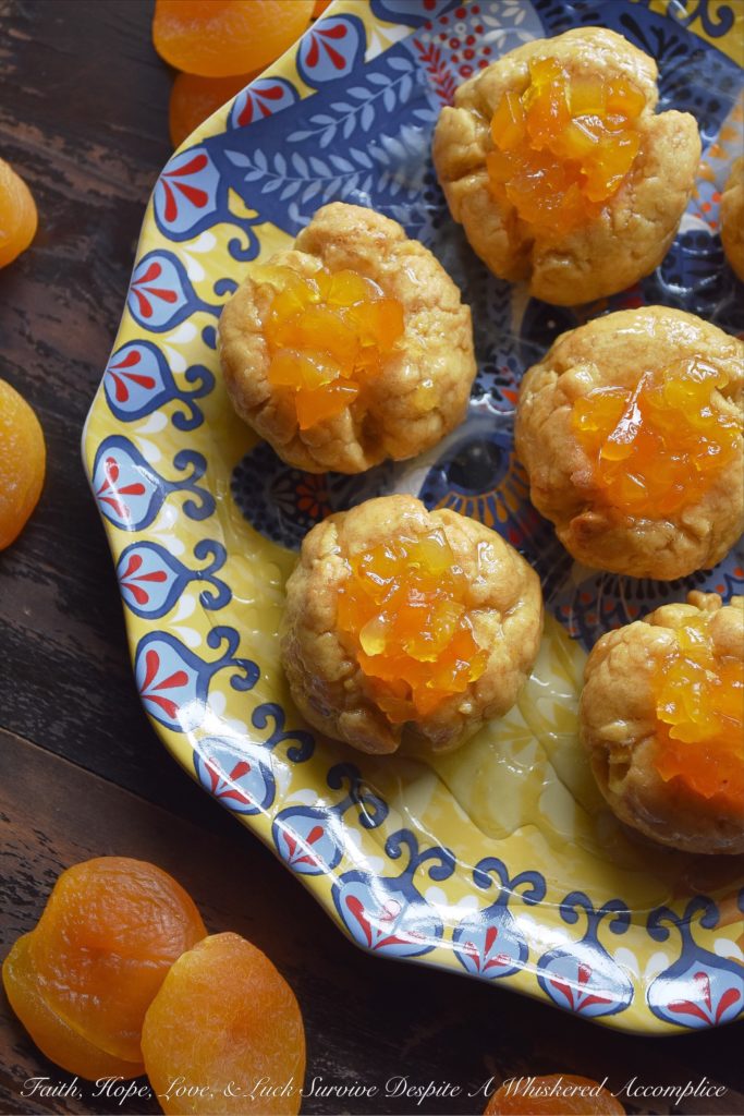 Apricot Sekerpare (Turkish Thumbprint Cookies) - These Turkish Sekerpare thumbprint cookies are like little biscuits with a nutty semolina texture. After being baked, the cookies are drenched, while still warm, in an apricot-infused syrup and then topped with finely candied Turkish apricots. They're sweet, crumbly, and absolutely divine.