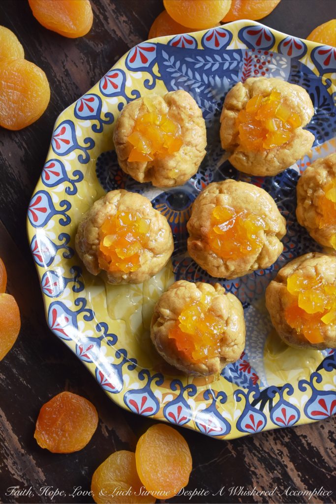 Apricot Sekerpare (Turkish Thumbprint Cookies) - These Turkish Sekerpare thumbprint cookies are like little biscuits with a nutty semolina texture. After being baked, the cookies are drenched, while still warm, in an apricot-infused syrup and then topped with finely candied Turkish apricots. They're sweet, crumbly, and absolutely divine.