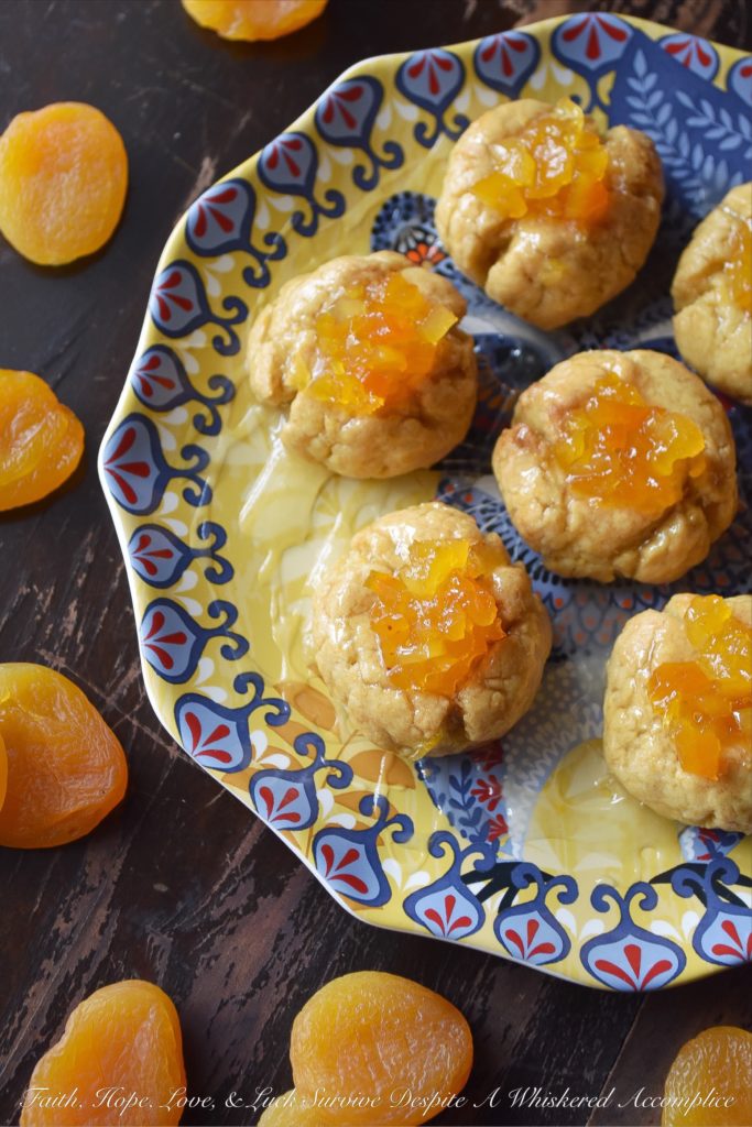 Apricot Sekerpare (Turkish Thumbprint Cookies) - These Turkish Sekerpare thumbprint cookies are like little biscuits with a nutty semolina texture. After being baked, the cookies are drenched, while still warm, in an apricot-infused syrup and then topped with finely candied Turkish apricots. They're sweet, crumbly, and absolutely divine.