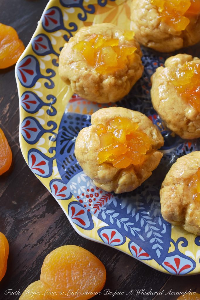 Apricot Sekerpare (Turkish Thumbprint Cookies) - These Turkish Sekerpare thumbprint cookies are like little biscuits with a nutty semolina texture. After being baked, the cookies are drenched, while still warm, in an apricot-infused syrup and then topped with finely candied Turkish apricots. They're sweet, crumbly, and absolutely divine.