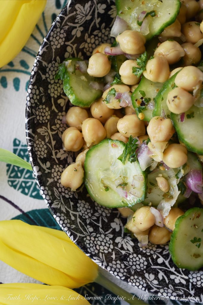 Tangy Chickpea & English Cucumber Salad - Canned chickpeas are transformed into a healthy and flavorful side salad with the addition of thinly sliced English cucumbers, finely diced red onions, as well as both fresh and dried herbs and seasonings. This healthy tangy lemon chickpea salad will soon become a family favorite recipe you won't have to feel the least bit guilty about.