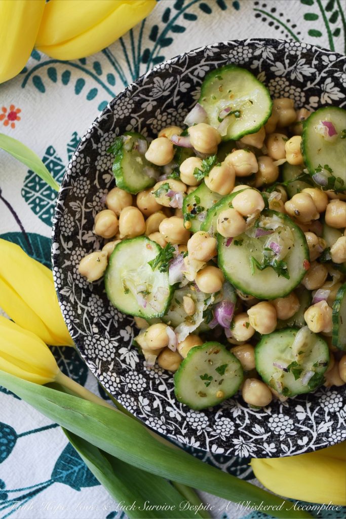 Tangy Chickpea & English Cucumber Salad - Canned chickpeas are transformed into a healthy and flavorful side salad with the addition of thinly sliced English cucumbers, finely diced red onions, as well as both fresh and dried herbs and seasonings. This healthy tangy lemon chickpea salad will soon become a family favorite recipe you won't have to feel the least bit guilty about.
