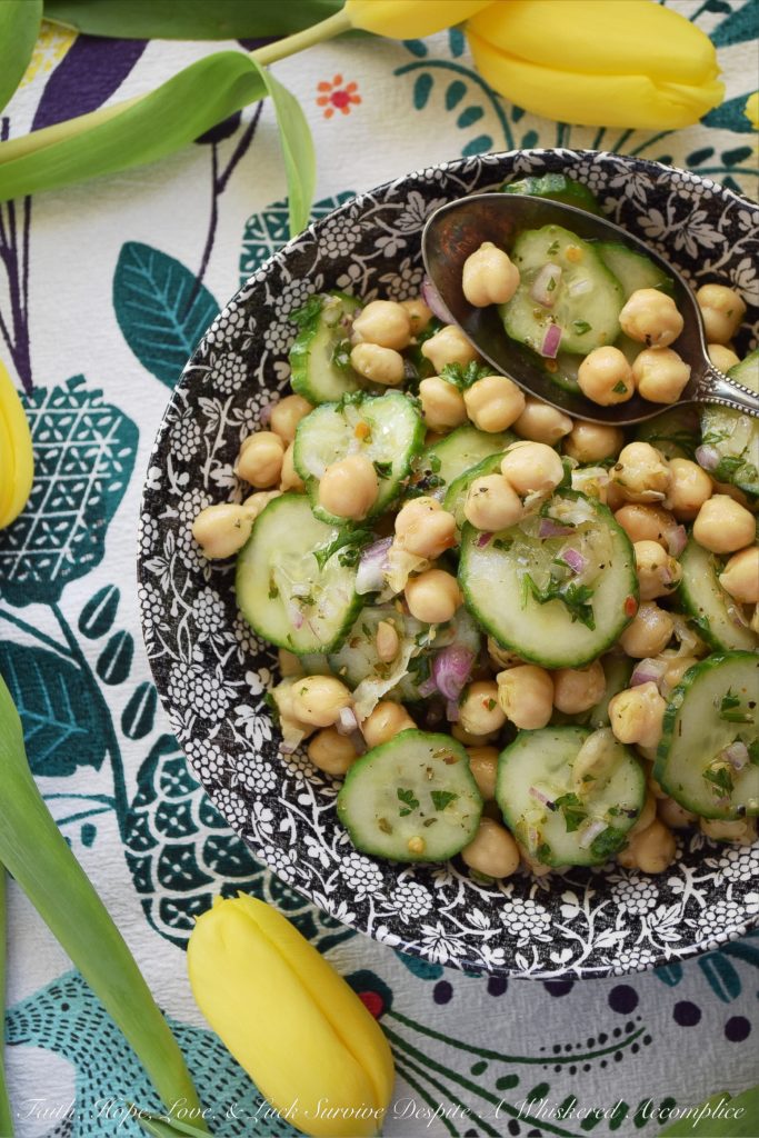 Tangy Chickpea & English Cucumber Salad - Canned chickpeas are transformed into a healthy and flavorful side salad with the addition of thinly sliced English cucumbers, finely diced red onions, as well as both fresh and dried herbs and seasonings. This healthy tangy lemon chickpea salad will soon become a family favorite recipe you won't have to feel the least bit guilty about.