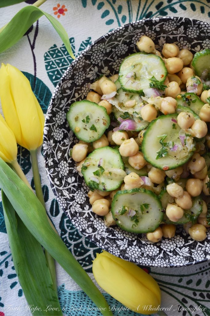 Tangy Chickpea & English Cucumber Salad - Canned chickpeas are transformed into a healthy and flavorful side salad with the addition of thinly sliced English cucumbers, finely diced red onions, as well as both fresh and dried herbs and seasonings. This healthy tangy lemon chickpea salad will soon become a family favorite recipe you won't have to feel the least bit guilty about.