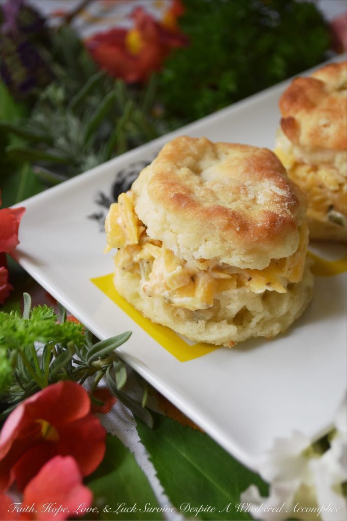 Southern Cheese Spread Tea Party Biscuits - Every tea party needs a few savory food options to balance out the menu and these bread and butter pickle buttermilk biscuits filled with a flavorful southern cheese spread definitely fill that need. They're the perfect size for snacking too, which means that you may want to make more than one batch because they'll disappear surprisingly fast.