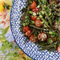 Roasted Asian Green Bean Salad with Tomatoes - When summer hits, it always seems to bring an excess of summer vegetables for us to deal with. This flavorful roasted green bean salad uses Asian flavors to create a unique and delicious side salad to help you use up some of those fresh garden green beans and cherry tomatoes before they go bad.