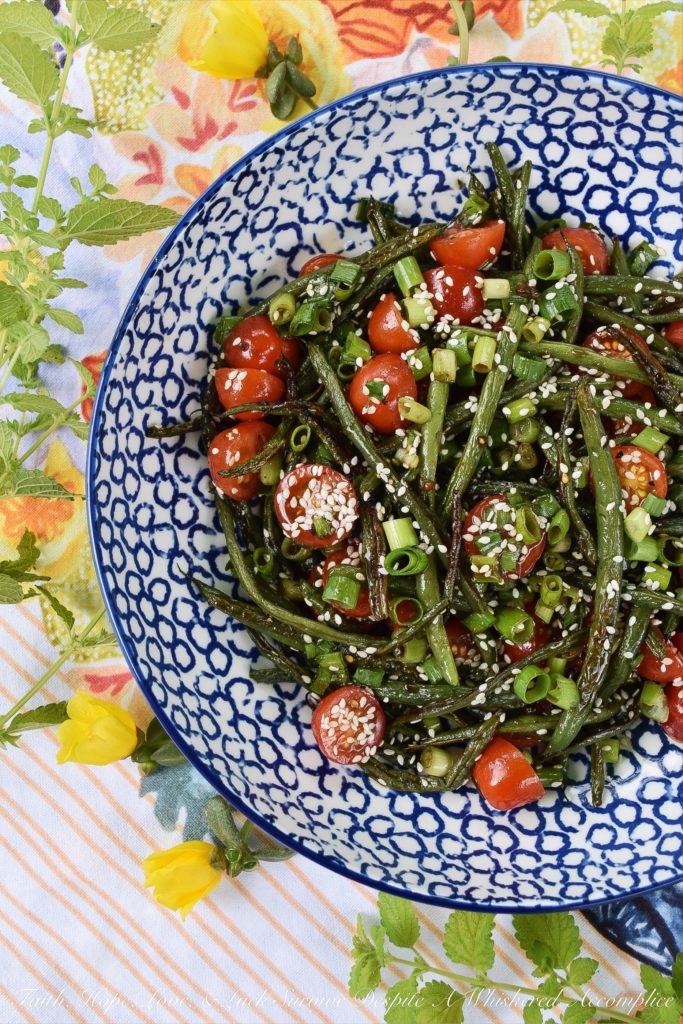 Roasted Asian Green Bean Salad with Tomatoes - When summer hits, it always seems to bring an excess of summer vegetables for us to deal with. This flavorful roasted green bean salad uses Asian flavors to create a unique and delicious side salad to help you use up some of those fresh garden green beans and cherry tomatoes before they go bad.