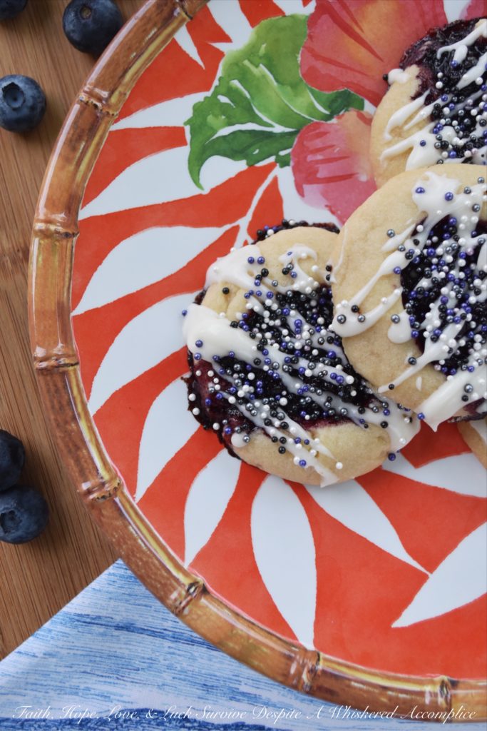 Honey & Balsamic Blueberry Jam Cookies - These buttery summer thumbprint cookies are filled with a slightly sweet homemade saucy honey & balsamic vinegar blueberry jam. After being baked to perfection, they are then lightly garnished with drizzle and a generous amount of sprinkles. These cookies are buttery, sweet, crumbly, and crunchy all at the same time, they're basically the perfect cookie.
