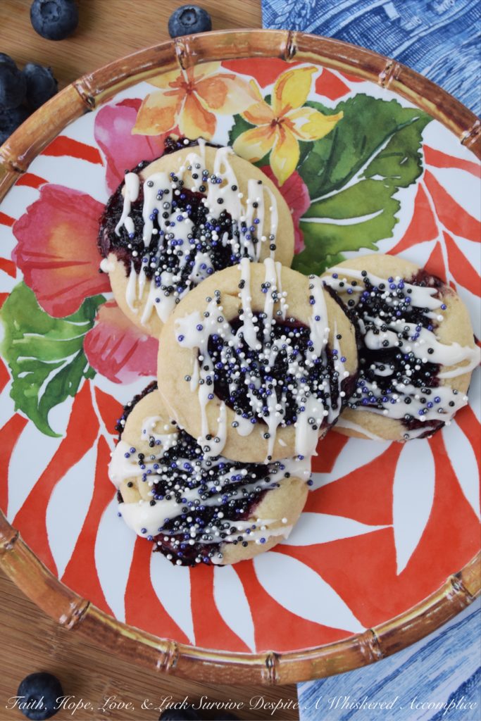 Honey & Balsamic Blueberry Jam Cookies - These buttery summer thumbprint cookies are filled with a slightly sweet homemade saucy honey & balsamic vinegar blueberry jam. After being baked to perfection, they are then lightly garnished with drizzle and a generous amount of sprinkles. These cookies are buttery, sweet, crumbly, and crunchy all at the same time, they're basically the perfect cookie.