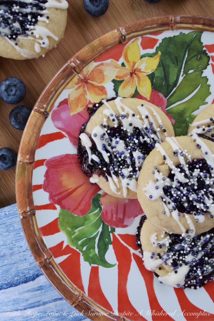 Honey & Balsamic Blueberry Jam Cookies - These buttery summer thumbprint cookies are filled with a slightly sweet homemade saucy honey & balsamic vinegar blueberry jam. After being baked to perfection, they are then lightly garnished with drizzle and a generous amount of sprinkles. These cookies are buttery, sweet, crumbly, and crunchy all at the same time, they're basically the perfect cookie.