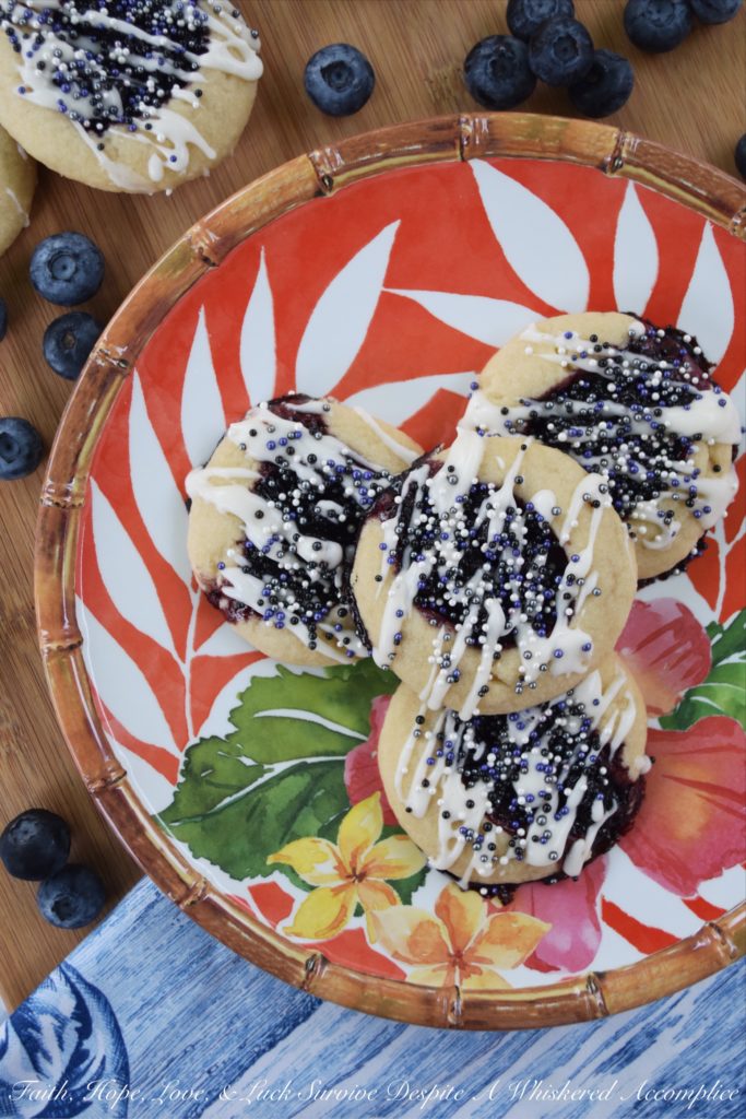 Honey & Balsamic Blueberry Jam Cookies - These buttery summer thumbprint cookies are filled with a slightly sweet homemade saucy honey & balsamic vinegar blueberry jam. After being baked to perfection, they are then lightly garnished with drizzle and a generous amount of sprinkles. These cookies are buttery, sweet, crumbly, and crunchy all at the same time, they're basically the perfect cookie.