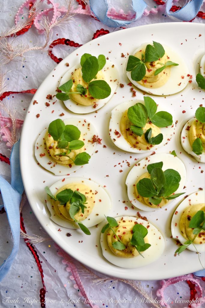 Deviled Eggs with Lemon & Pink Peppercorns - What can I say about these fabulous deviled eggs? They're traditional deviled eggs, only kicked up a notch. That's what happens when you add a hint of fresh lemon juice, lots of lemon zest, and just the right amount of finely ground pink peppercorns. These little deviled egg beauties are fresh, zingy, peppery, and just begging to be devoured.