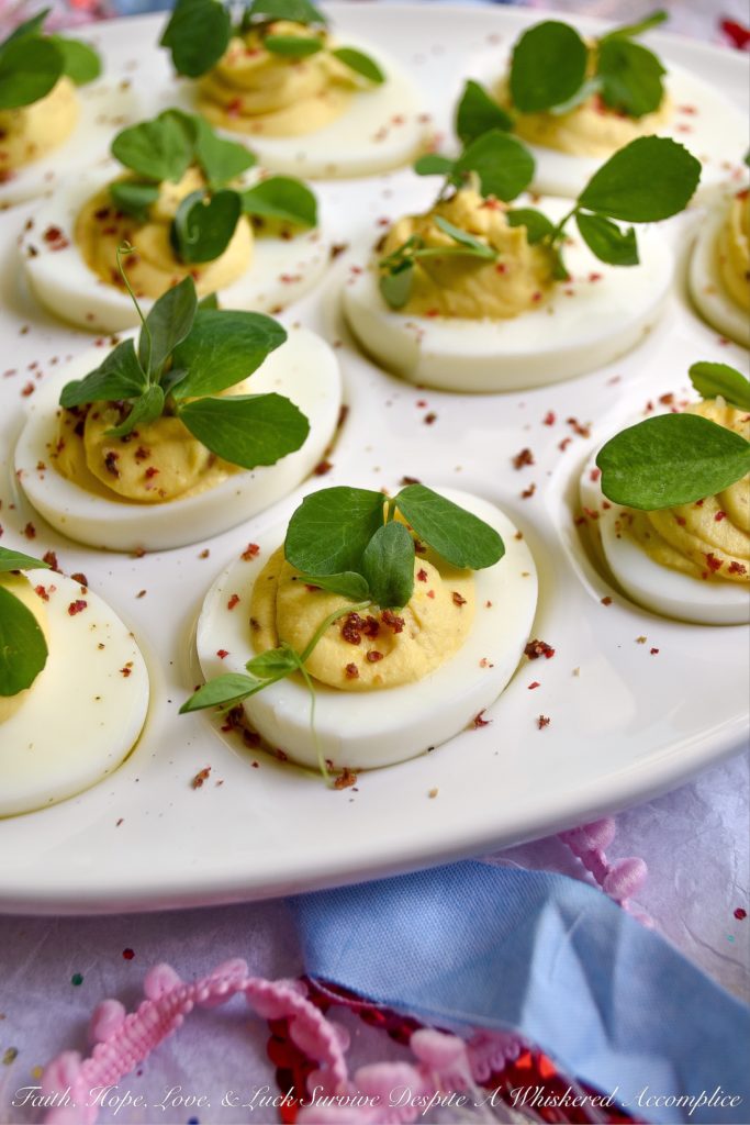 Deviled Eggs with Lemon & Pink Peppercorns - What can I say about these fabulous deviled eggs? They're traditional deviled eggs, only kicked up a notch. That's what happens when you add a hint of fresh lemon juice, lots of lemon zest, and just the right amount of finely ground pink peppercorns. These little deviled egg beauties are fresh, zingy, peppery, and just begging to be devoured.