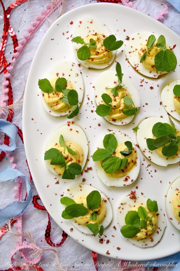 Deviled Eggs with Lemon & Pink Peppercorns - What can I say about these fabulous deviled eggs? They're traditional deviled eggs, only kicked up a notch. That's what happens when you add a hint of fresh lemon juice, lots of lemon zest, and just the right amount of finely ground pink peppercorns. These little deviled egg beauties are fresh, zingy, peppery, and just begging to be devoured.