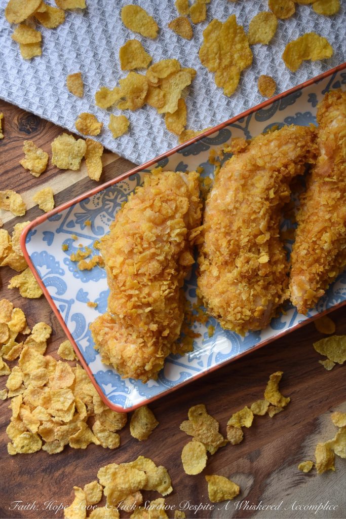 Crunchy Corn Flake Oven-Baked Chicken Tenders - Baking chicken on a busy weeknight doesn't get any easier than with these crunchy corn flake-coated chicken tenders. Assembly alone will take you a whopping five minutes and allow you the opportunity to take out some of your daily frustration when crushing the corn flakes. Add approximately 20 minutes of baking time and dinner is served. Now, was that so hard?