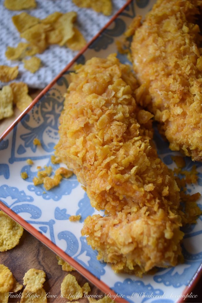 Crunchy Corn Flake Oven-Baked Chicken Tenders - Baking chicken on a busy weeknight doesn't get any easier than with these crunchy corn flake-coated chicken tenders. Assembly alone will take you a whopping five minutes and allow you the opportunity to take out some of your daily frustration when crushing the corn flakes. Add approximately 20 minutes of baking time and dinner is served. Now, was that so hard?
