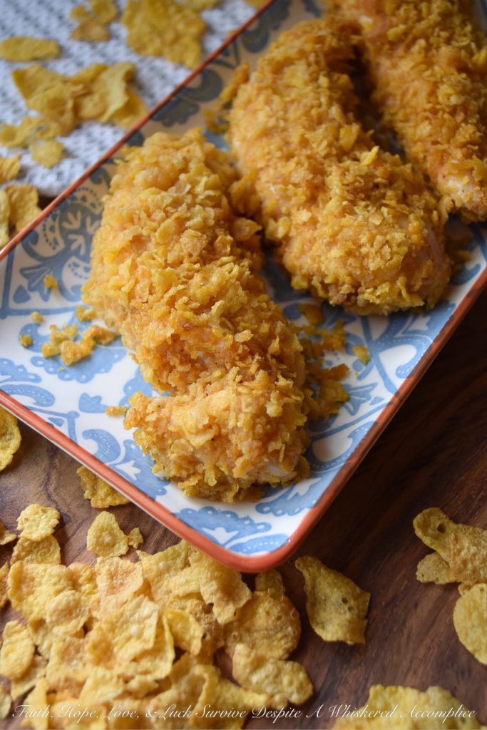 Crunchy Corn Flake Oven-Baked Chicken Tenders - Baking chicken on a busy weeknight doesn't get any easier than with these crunchy corn flake-coated chicken tenders. Assembly alone will take you a whopping five minutes and allow you the opportunity to take out some of your daily frustration when crushing the corn flakes. Add approximately 20 minutes of baking time and dinner is served. Now, was that so hard?