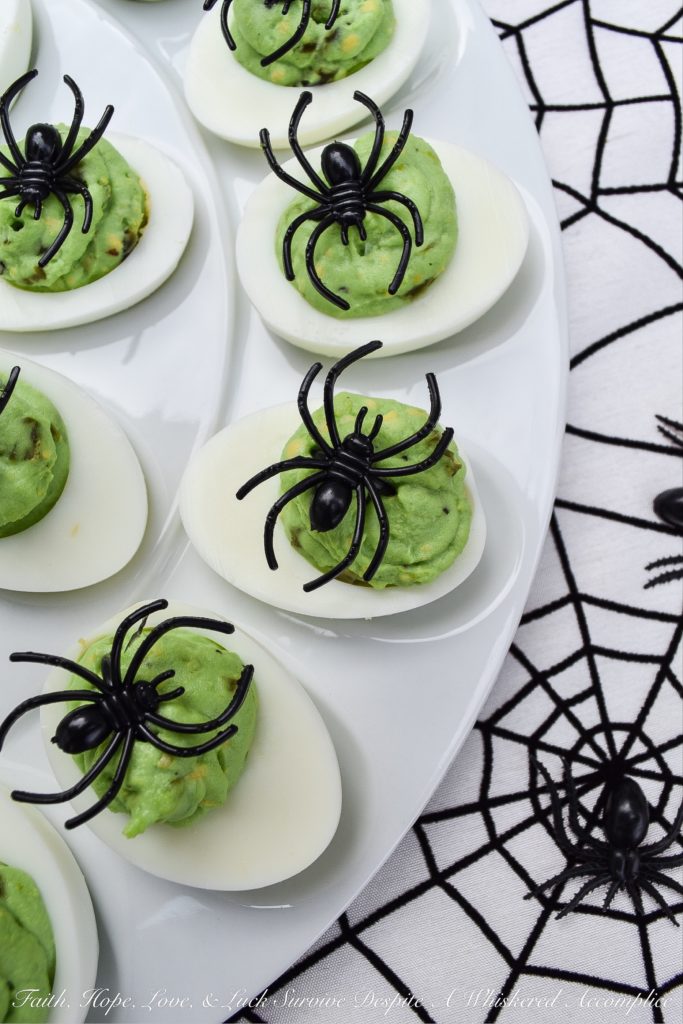 Halloween Monster Mash Jalapeño Deviled Eggs - These sweet and spicy monster mash deviled eggs are the perfect party treat to share with your ghouls and goblins this Halloween season. Finely diced candied jalapeños are the secret to their amazing flavor. Add in a bit of green food coloring and a spider garnish on top for just the right festive holiday touch.