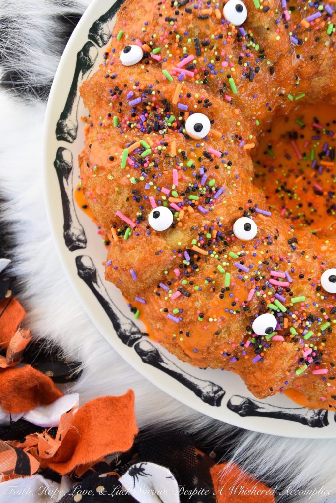 Halloween-Inspired Orange Ricotta Bundt Cake - The secret to this light, moist, and airy Bundt cake is the ricotta cheese it contains, as well as the added orange zest and juice, which help give it a lovely citrus flavor. Topping it with an orange powdered sugar glaze, followed by festive Halloween sprinkles and candy eyeballs, also helps to give this holiday cake the perfect touch of spooky cuteness.