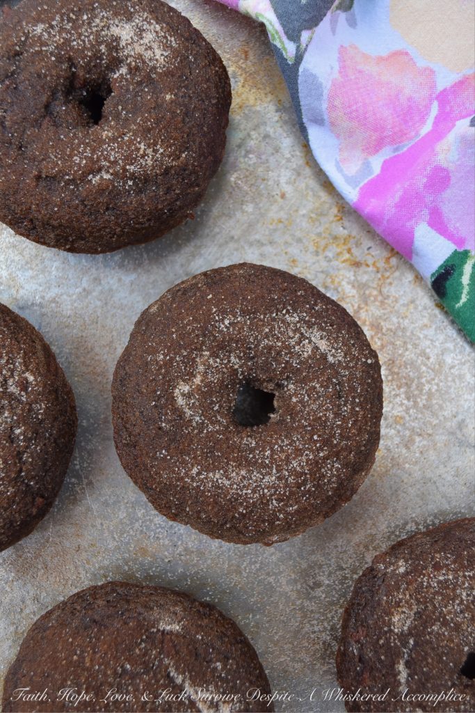 Baked Chocolate Spice Crumb Cake Donuts - These crumbly spiced chocolate cake donuts have just the right amount of ginger and cinnamon to make them absolutely delicious. And, since they're brushed with melted butter and then generously sprinkled with a cinnamon sugar topping, you won't even mind the fact that they aren't glazed.