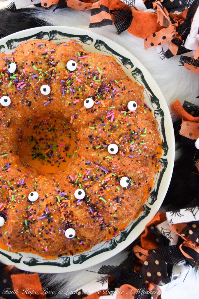 Halloween-Inspired Orange Ricotta Bundt Cake - The secret to this light, moist, and airy Bundt cake is the ricotta cheese it contains, as well as the added orange zest and juice, which help give it a lovely citrus flavor. Topping it with an orange powdered sugar glaze, followed by festive Halloween sprinkles and candy eyeballs, also helps to give this holiday cake the perfect touch of spooky cuteness.
