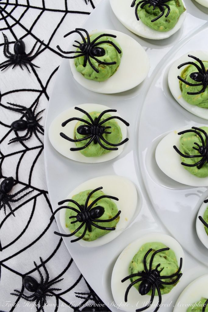 Halloween Monster Mash Jalapeño Deviled Eggs - These sweet and spicy monster mash deviled eggs are the perfect party treat to share with your ghouls and goblins this Halloween season. Finely diced candied jalapeños are the secret to their amazing flavor. Add in a bit of green food coloring and a spider garnish on top for just the right festive holiday touch.