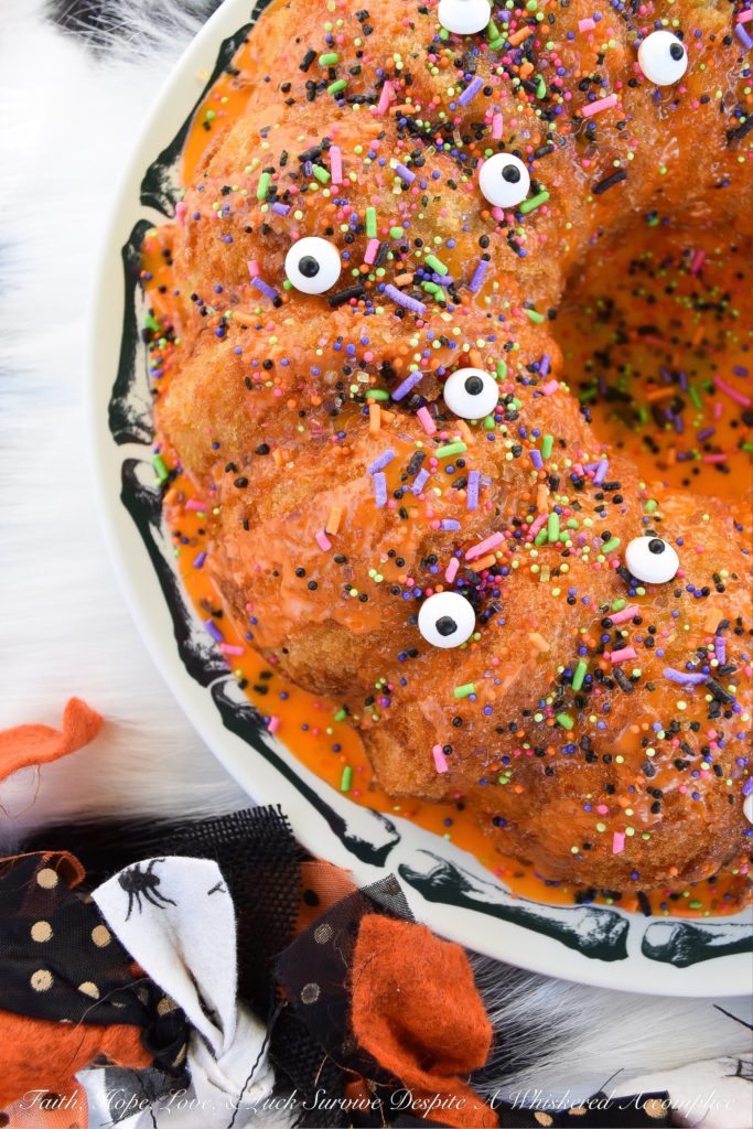 Halloween-Inspired Orange Ricotta Bundt Cake - The secret to this light, moist, and airy Bundt cake is the ricotta cheese it contains, as well as the added orange zest and juice, which help give it a lovely citrus flavor. Topping it with an orange powdered sugar glaze, followed by festive Halloween sprinkles and candy eyeballs, also helps to give this holiday cake the perfect touch of spooky cuteness.