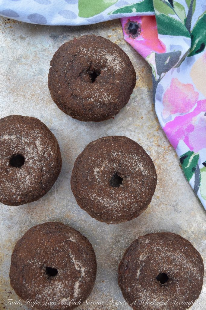 Baked Chocolate Spice Crumb Cake Donuts - These crumbly spiced chocolate cake donuts have just the right amount of ginger and cinnamon to make them absolutely delicious. And, since they're brushed with melted butter and then generously sprinkled with a cinnamon sugar topping, you won't even mind the fact that they aren't glazed.