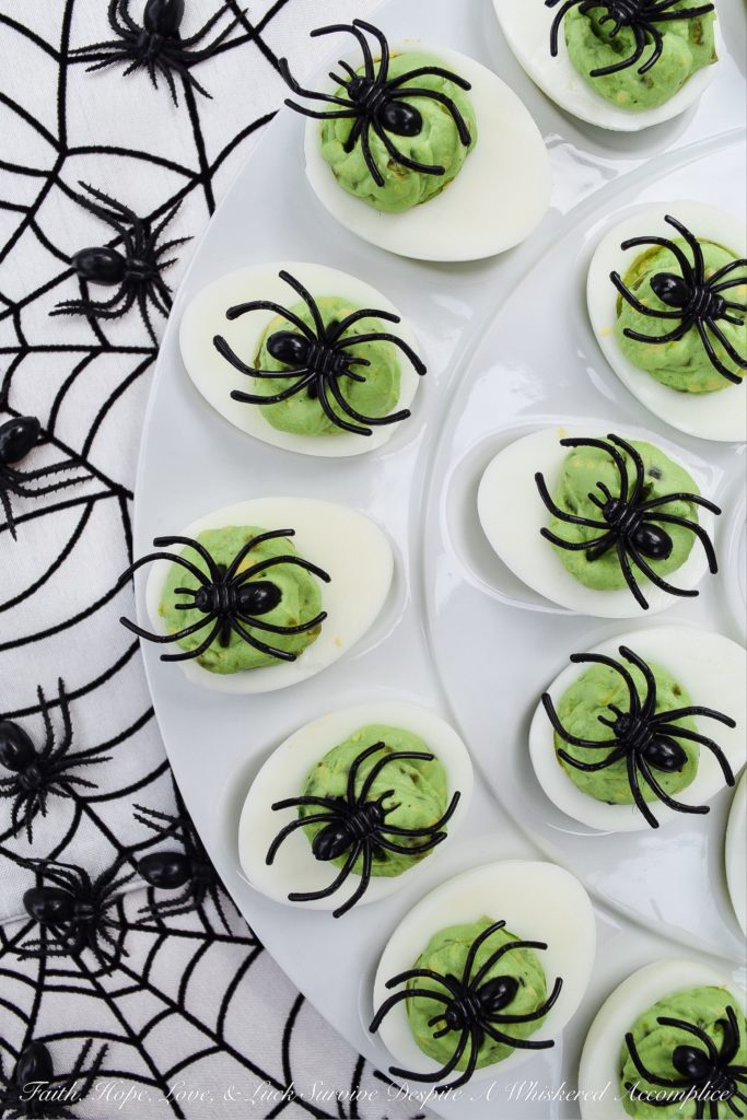 Halloween Monster Mash Jalapeño Deviled Eggs - These sweet and spicy monster mash deviled eggs are the perfect party treat to share with your ghouls and goblins this Halloween season. Finely diced candied jalapeños are the secret to their amazing flavor. Add in a bit of green food coloring and a spider garnish on top for just the right festive holiday touch.