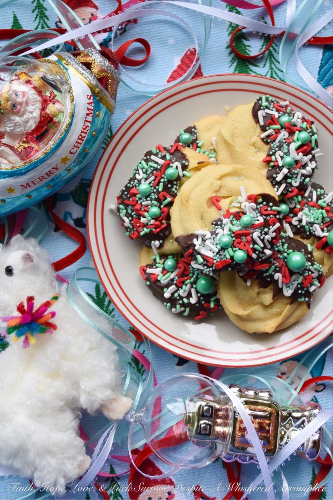 Chocolate-Dipped Christmas Butter Cookies - What's better than a holiday butter cookie? A festive Christmas holiday butter cookie dipped in chocolate and covered with sprinkles. Yup, chocolate-dipped butter cookies definitely make the holidays worth celebrating.