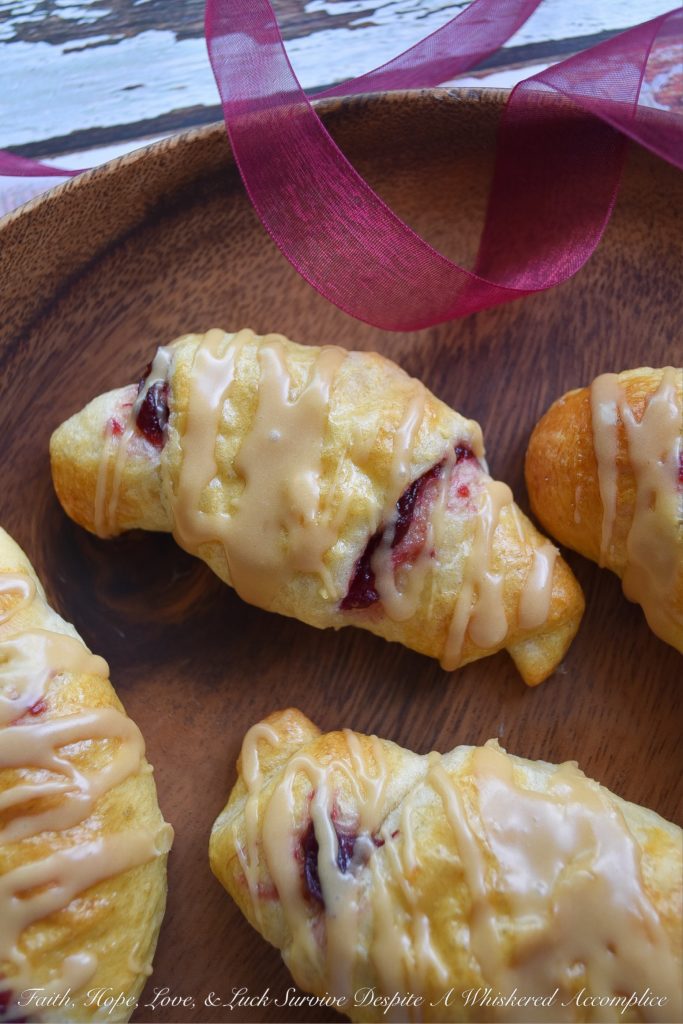 Cranberry Crescent Rolls with Maple Icing - A little leftover cranberry sauce goes a long way when used in these light and airy cranberry crescent rolls drizzled with maple icing. So this Thanksgiving, make sure you have enough cranberry sauce to make these for breakfast. They're the perfect way to start off the holiday and you'll love how fast, simple, and delicious they are.