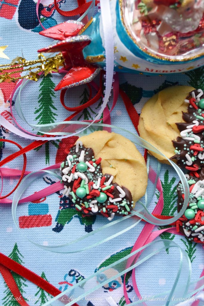 Chocolate-Dipped Christmas Butter Cookies - What's better than a holiday butter cookie? A festive Christmas holiday butter cookie dipped in chocolate and covered with sprinkles. Yup, chocolate-dipped butter cookies definitely make the holidays worth celebrating.