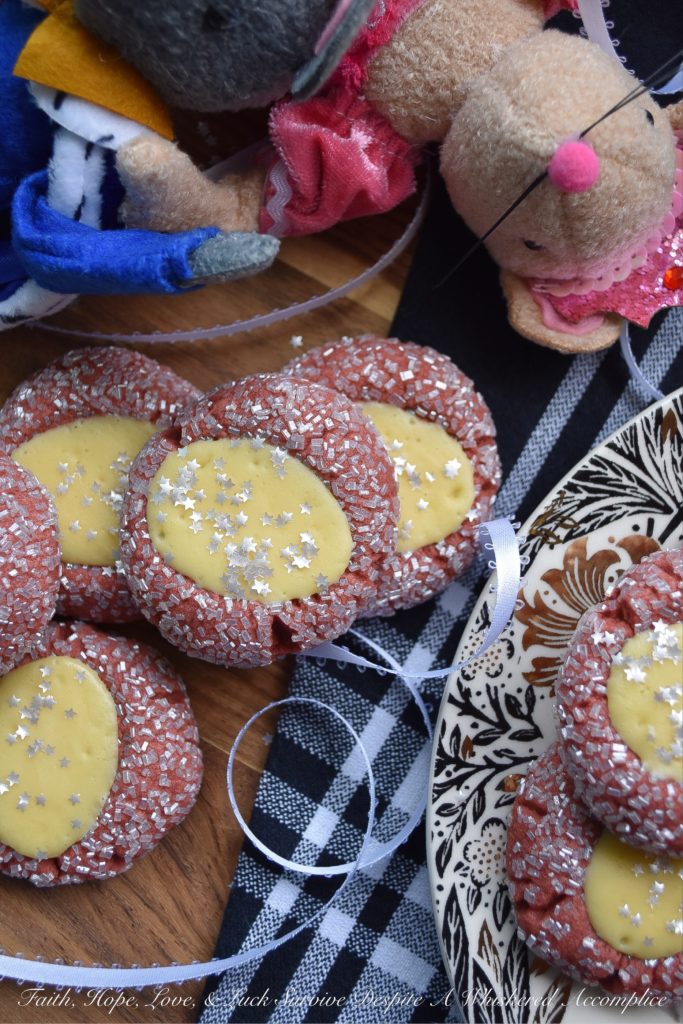 Cream Cheese Red Velvet Thumbprint Cookies - These festive sugar-coated thumbprint cookies are the perfect Christmas cookie, thanks to their red color and shimmery appearance. And, after being filled with a cream cheese filling, they're just as delicious as they are beautiful.