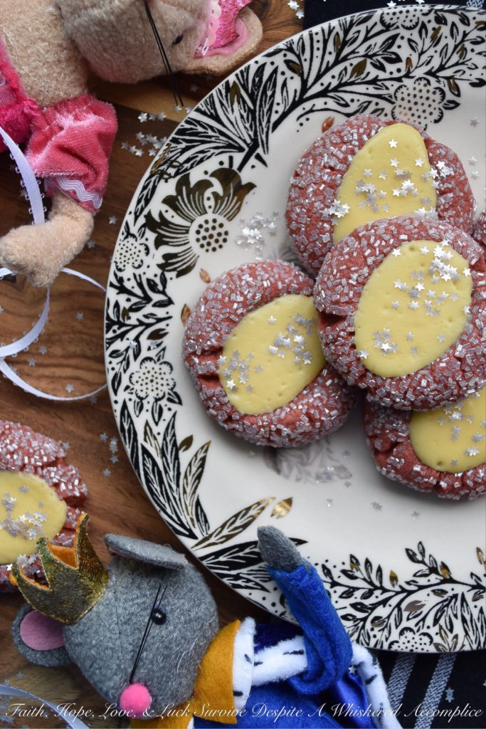 Cream Cheese Red Velvet Thumbprint Cookies - These festive sugar-coated thumbprint cookies are the perfect Christmas cookie, thanks to their red color and shimmery appearance. And, after being filled with a cream cheese filling, they're just as delicious as they are beautiful.