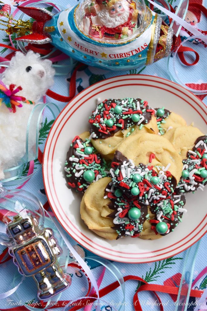 Chocolate-Dipped Christmas Butter Cookies - What's better than a holiday butter cookie? A festive Christmas holiday butter cookie dipped in chocolate and covered with sprinkles. Yup, chocolate-dipped butter cookies definitely make the holidays worth celebrating.