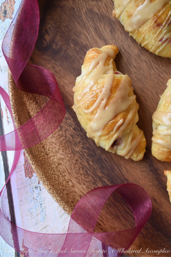 Cranberry Crescent Rolls with Maple Icing - A little leftover cranberry sauce goes a long way when used in these light and airy cranberry crescent rolls drizzled with maple icing. So this Thanksgiving, make sure you have enough cranberry sauce to make these for breakfast. They're the perfect way to start off the holiday and you'll love how fast, simple, and delicious they are.