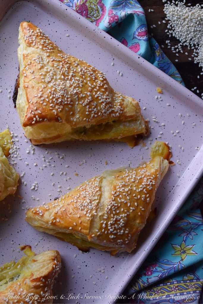 Easy Middle Eastern Puff Pastry Cheese Bourekas = Bourekas are a Middle Eastern puff pastry treat that you will instantly fall in love with at first bite. These particular easy-to-make cheese bourekas are filled with crumbled feta, fresh mozzarella, a generous amount of fresh parsley, and a hint of lemon zest. Not only are they fresh, airy, and flakey, they're also pillowy puffs of cheesy goodness. You'll absolutely love how easy they are to make.