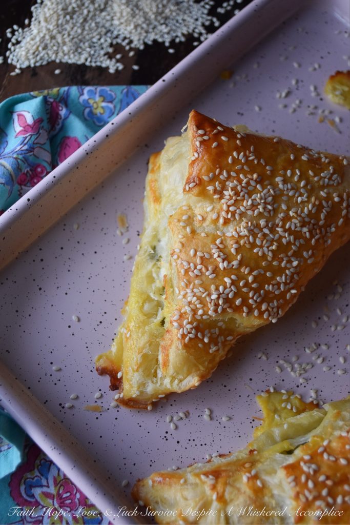 Easy Middle Eastern Puff Pastry Cheese Bourekas = Bourekas are a Middle Eastern puff pastry treat that you will instantly fall in love with at first bite. These particular easy-to-make cheese bourekas are filled with crumbled feta, fresh mozzarella, a generous amount of fresh parsley, and a hint of lemon zest. Not only are they fresh, airy, and flakey, they're also pillowy puffs of cheesy goodness. You'll absolutely love how easy they are to make.
