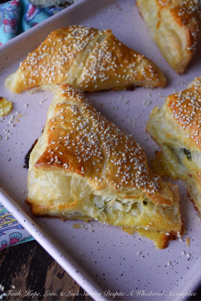 Easy Middle Eastern Puff Pastry Cheese Bourekas = Bourekas are a Middle Eastern puff pastry treat that you will instantly fall in love with at first bite. These particular easy-to-make cheese bourekas are filled with crumbled feta, fresh mozzarella, a generous amount of fresh parsley, and a hint of lemon zest. Not only are they fresh, airy, and flakey, they're also pillowy puffs of cheesy goodness. You'll absolutely love how easy they are to make.