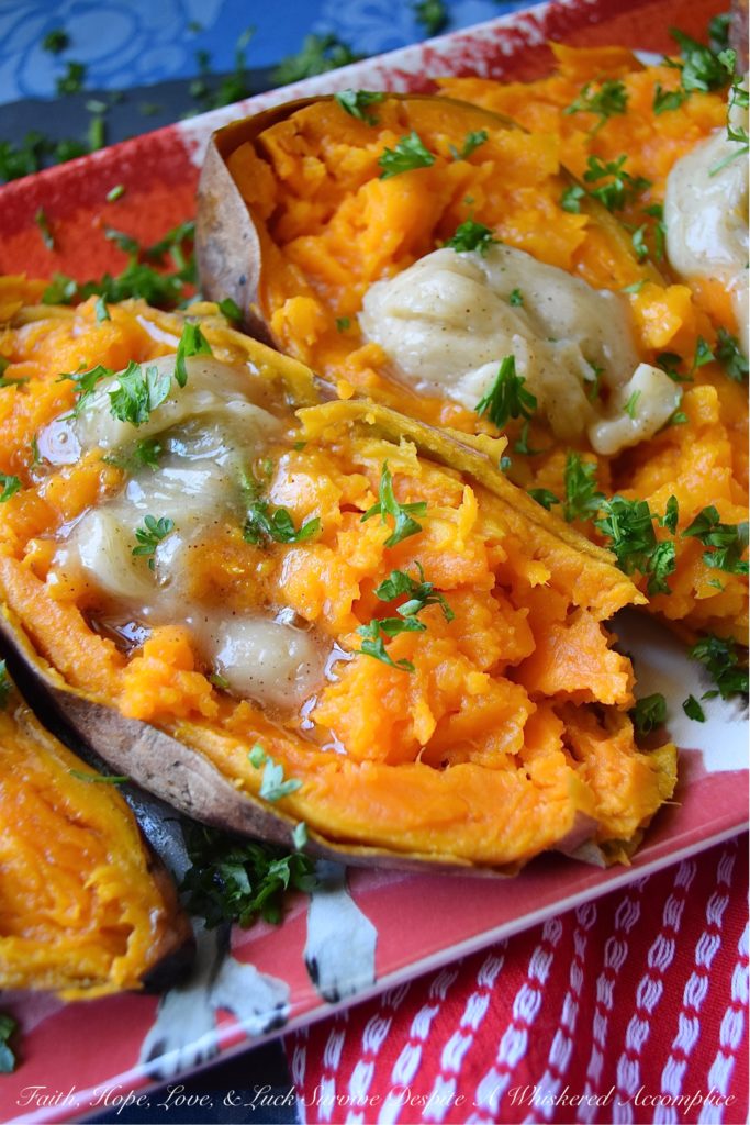 Maple & Honey Butter Crockpot Sweet Potatoes - After making sweet potatoes in a crockpot or slow cooker, you may never make them any other way. They are perfectly tender and ready to top with your favorite fixings after only six hands-off hours of slow cooking. In this simple recipe, these sweet potatoes are topped with a sweet and flavorful homemade butter infused with maple and butter.