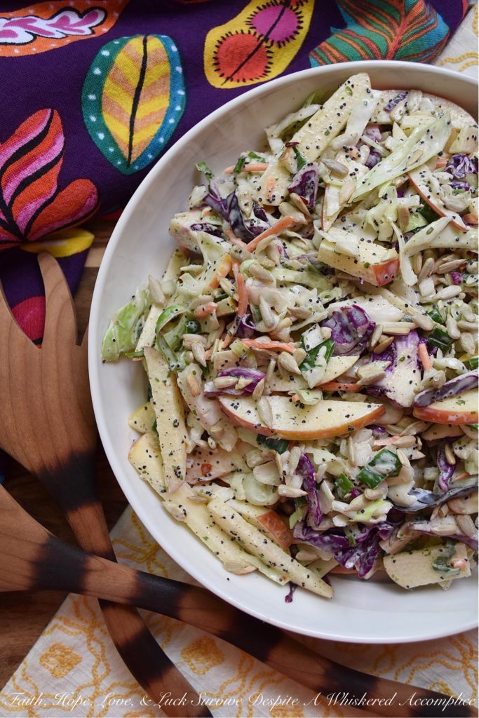Creamy Cabbage & Carrot Coleslaw with Apple - It's so easy to transform a simple bag of pre-shredded green cabbage, red cabbage, and carrots into an absolutely outstanding side salad. This particular creamy coleslaw recipe is made even more delicious with the addition of a crisp red apple and crunchy sunflower seeds. I'm fairly certain that this time-saving slaw is going to become one of your new favorite go-to summer recipes.