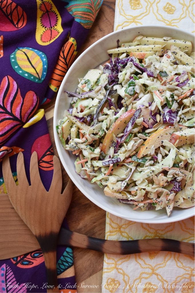 Creamy Cabbage & Carrot Coleslaw with Apple - It's so easy to transform a simple bag of pre-shredded green cabbage, red cabbage, and carrots into an absolutely outstanding side salad. This particular creamy coleslaw recipe is made even more delicious with the addition of a crisp red apple and crunchy sunflower seeds. I'm fairly certain that this time-saving slaw is going to become one of your new favorite go-to summer recipes.