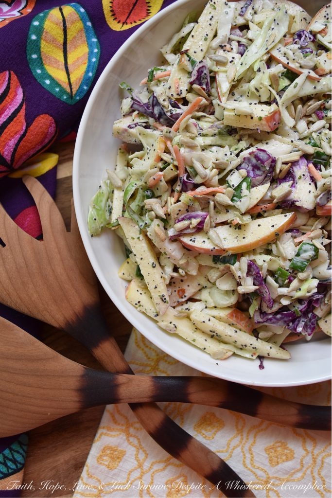 Creamy Cabbage & Carrot Coleslaw with Apple - It's so easy to transform a simple bag of pre-shredded green cabbage, red cabbage, and carrots into an absolutely outstanding side salad. This particular creamy coleslaw recipe is made even more delicious with the addition of a crisp red apple and crunchy sunflower seeds. I'm fairly certain that this time-saving slaw is going to become one of your new favorite go-to summer recipes.
