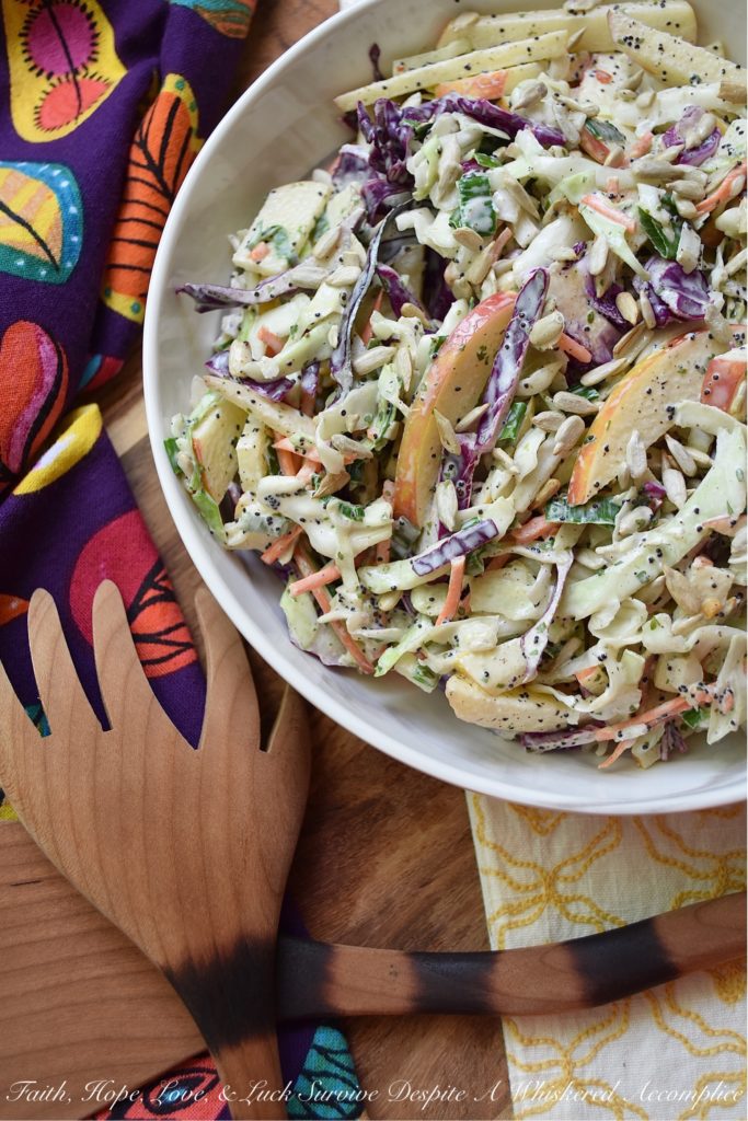 Creamy Cabbage & Carrot Coleslaw with Apple - It's so easy to transform a simple bag of pre-shredded green cabbage, red cabbage, and carrots into an absolutely outstanding side salad. This particular creamy coleslaw recipe is made even more delicious with the addition of a crisp red apple and crunchy sunflower seeds. I'm fairly certain that this time-saving slaw is going to become one of your new favorite go-to summer recipes.