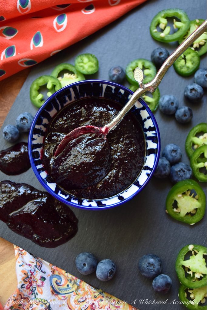 Blueberry & Jalapeño Fruit Butter Spread - Y'all, fruit butter is definitely where it's at. Unlike most jams, jellies, or preserves, it has a unique texture. It's not smooth and it's not chunky, instead, it's somewhere in between. And when you balance out the sweetness of this particular fruit butter with spicy jalapeños, it becomes something almost magical. Your mouth is gonna do a happy dance no matter what you choose to slather this fresh blueberry fruit butter spread on. Although, I personally, suggest a biscuit, English muffin, or crumbly piece of cornbread.