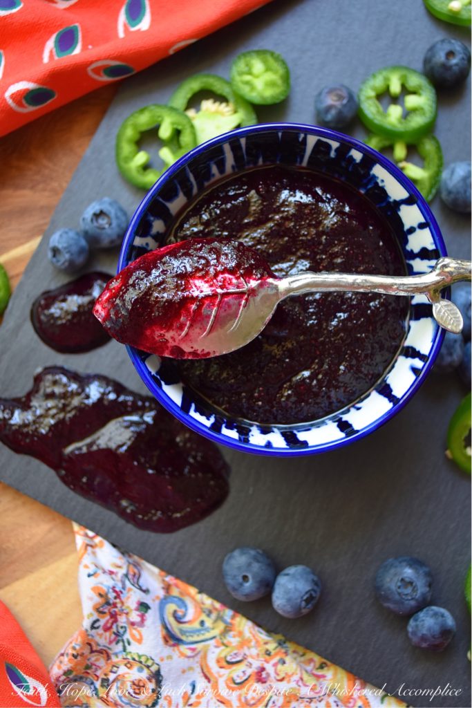 Blueberry & Jalapeño Fruit Butter Spread - Y'all, fruit butter is definitely where it's at. Unlike most jams, jellies, or preserves, it has a unique texture. It's not smooth and it's not chunky, instead, it's somewhere in between. And when you balance out the sweetness of this particular fruit butter with spicy jalapeños, it becomes something almost magical. Your mouth is gonna do a happy dance no matter what you choose to slather this fresh blueberry fruit butter spread on. Although, I personally, suggest a biscuit, English muffin, or crumbly piece of cornbread.