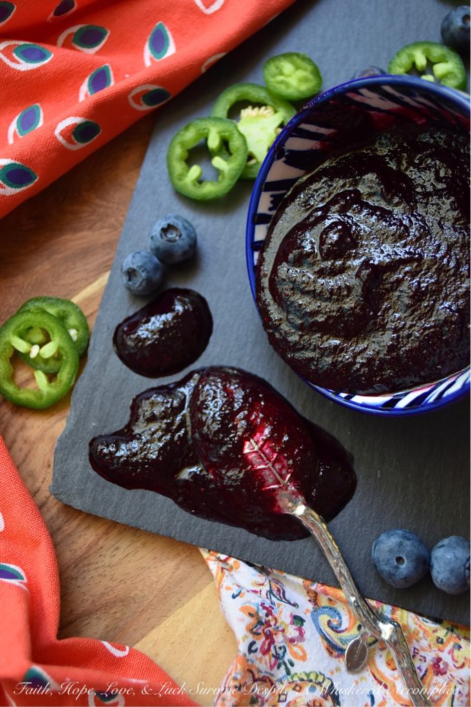 Blueberry & Jalapeño Fruit Butter Spread - Y'all, fruit butter is definitely where it's at. Unlike most jams, jellies, or preserves, it has a unique texture. It's not smooth and it's not chunky, instead, it's somewhere in between. And when you balance out the sweetness of this particular fruit butter with spicy jalapeños, it becomes something almost magical. Your mouth is gonna do a happy dance no matter what you choose to slather this fresh blueberry fruit butter spread on. Although, I personally, suggest a biscuit, English muffin, or crumbly piece of cornbread.
