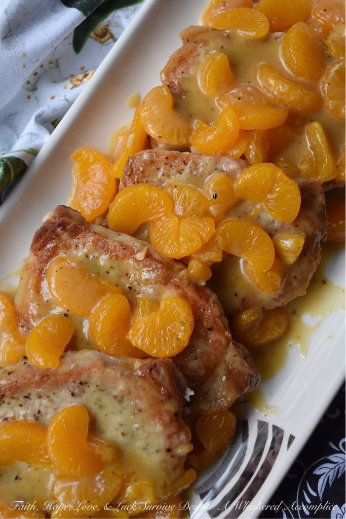 Mandarin Orange Honey Mustard Pork Chops - This may be one of the easiest fried pork chop recipes in the world. A little bit of salt and pepper, a quick flour dredge, and then a quick and easy pan fry in olive oil makes these pork chops the perfect option for a busy weeknight meal. And, once they are topped with a delicious mandarin orange honey mustard sauce, your mouth and your stomach are going to totally fall in love.