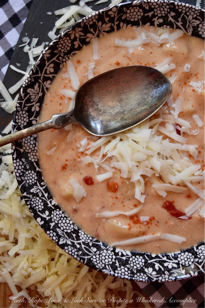 Southern Pimento Cheese Crockpot Potato Soup - If you're looking for a quick southern-inspired, easy-to-make, weekday bowl of creamy potato soup, then this is your recipe. Simply dump the soup ingredients into a crockpot and stir to combine. Eight hours later, purée half of the soup in a blender and then garnish each bowl of pimento cheese potato soup with some freshly grated white cheddar cheese right before serving. What could be more simple, or more delicious?
