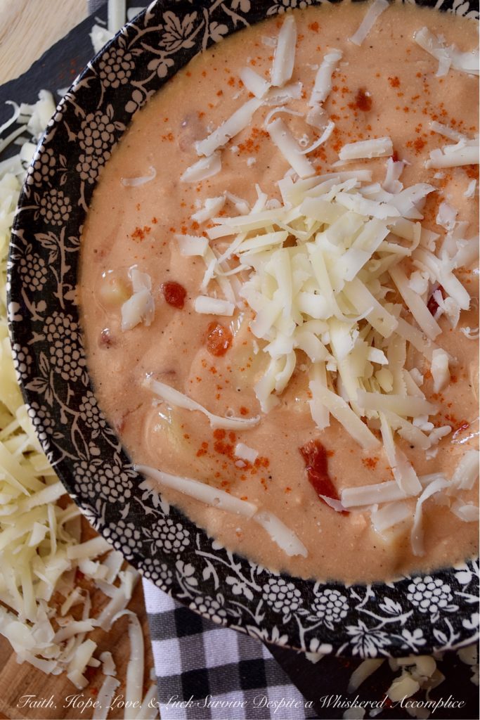 Southern Pimento Cheese Crockpot Potato Soup - If you're looking for a quick southern-inspired, easy-to-make, weekday bowl of creamy potato soup, then this is your recipe. Simply dump the soup ingredients into a crockpot and stir to combine. Eight hours later, purée half of the soup in a blender and then garnish each bowl of pimento cheese potato soup with some freshly grated white cheddar cheese right before serving. What could be more simple, or more delicious?